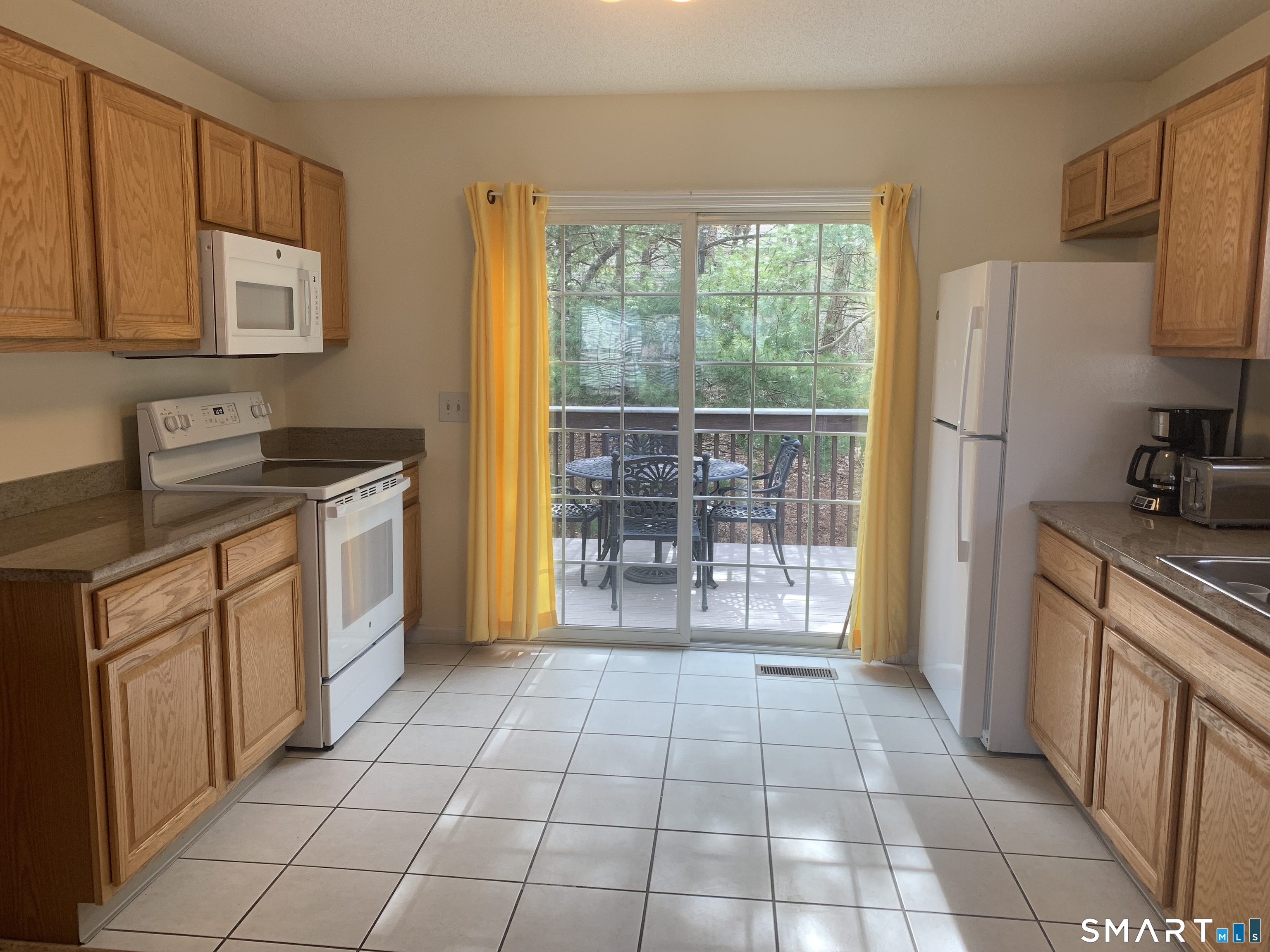 83 Danny's Way, Unit 83 Wallingford, CT 06492 - Photo 19 of 38 a kitchen with stainless steel appliances granite countertop a stove a sink and a refrigerator