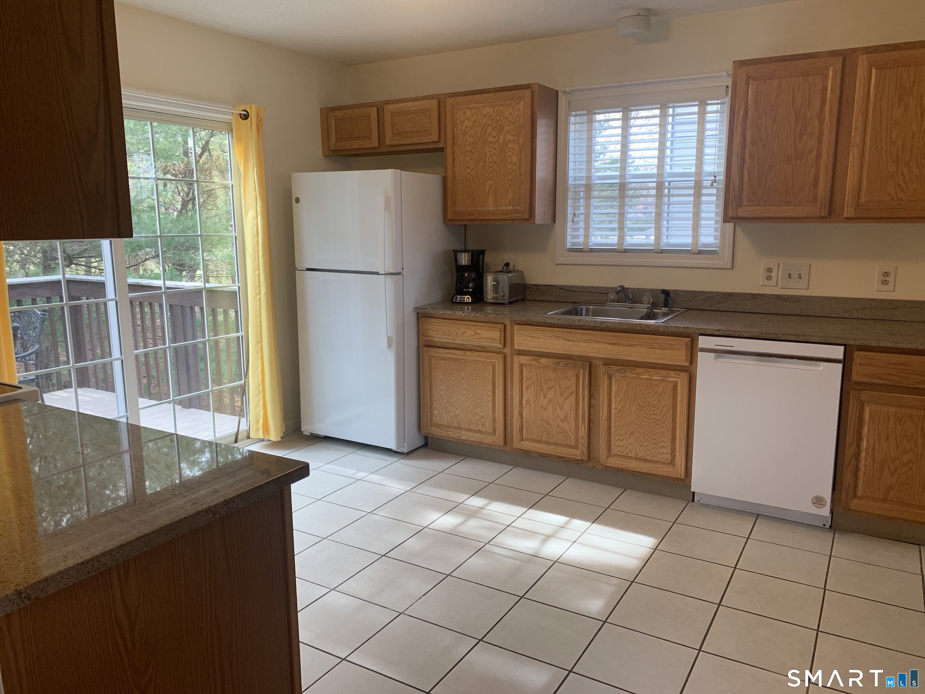 83 Danny's Way, Unit 83 Wallingford, CT 06492 - Photo 20 of 38 a kitchen with stainless steel appliances granite countertop a refrigerator sink and cabinets