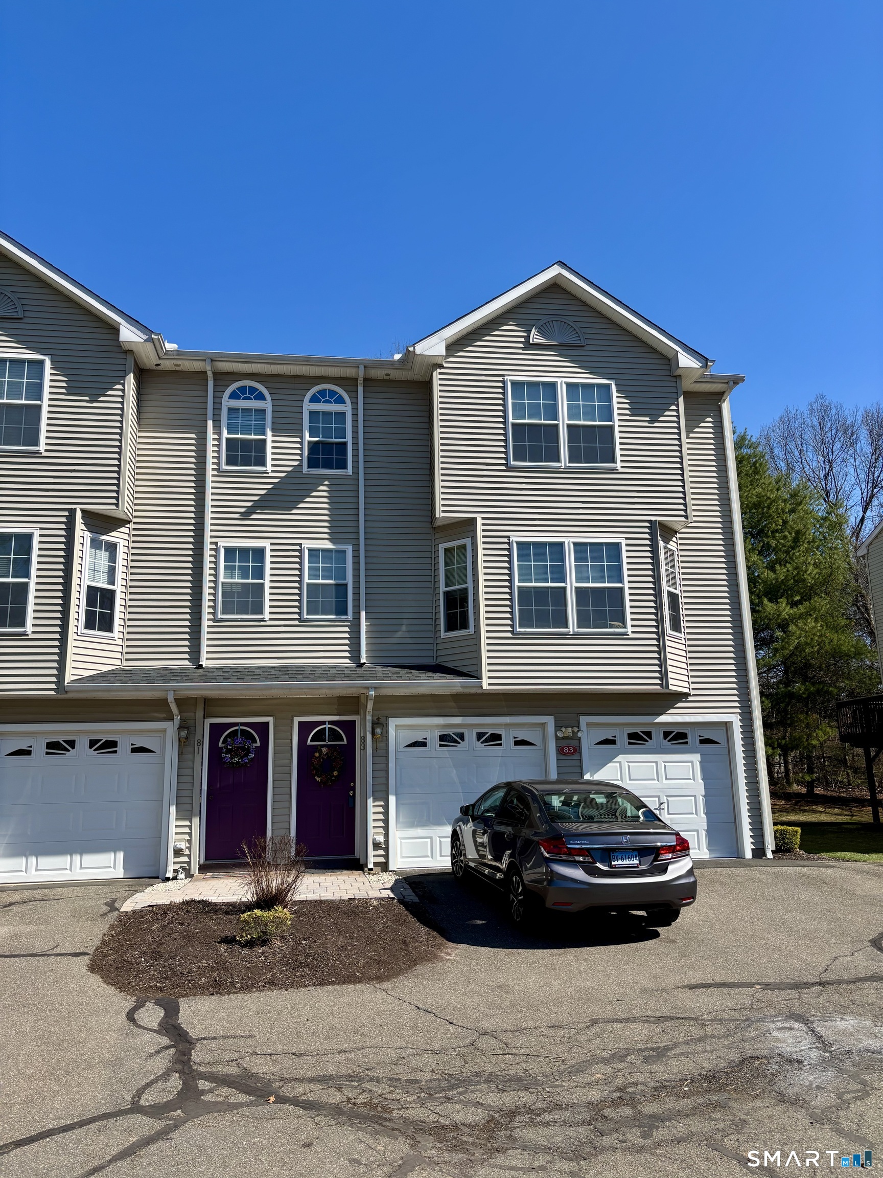 83 Danny's Way, Unit 83 Wallingford, CT 06492 - Photo 2 of 38 a front view of a house with cars parked