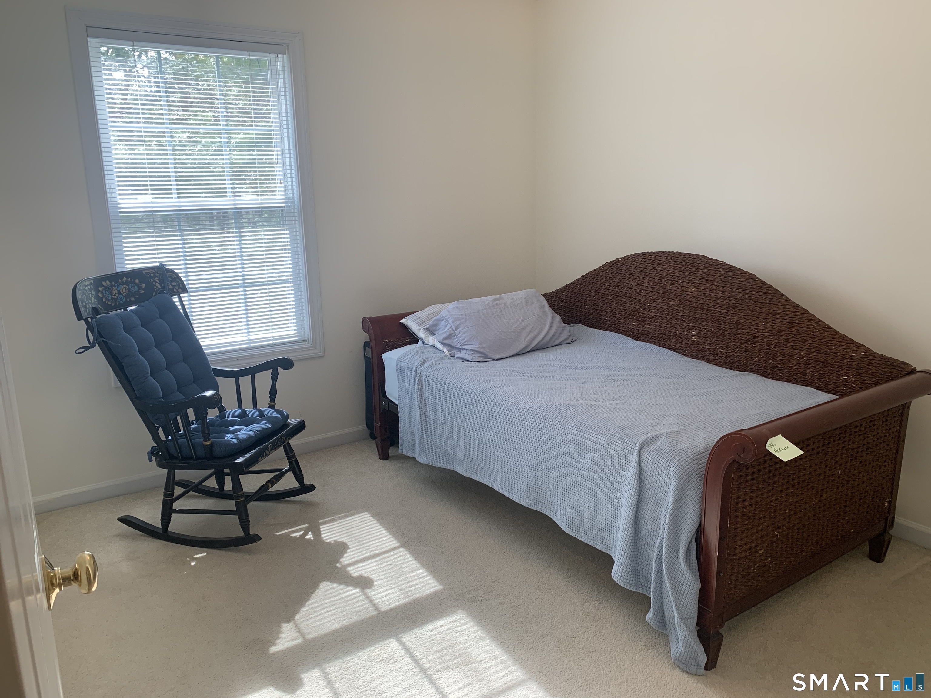 83 Danny's Way, Unit 83 Wallingford, CT 06492 - Photo 21 of 38 a bedroom with a bed and chair