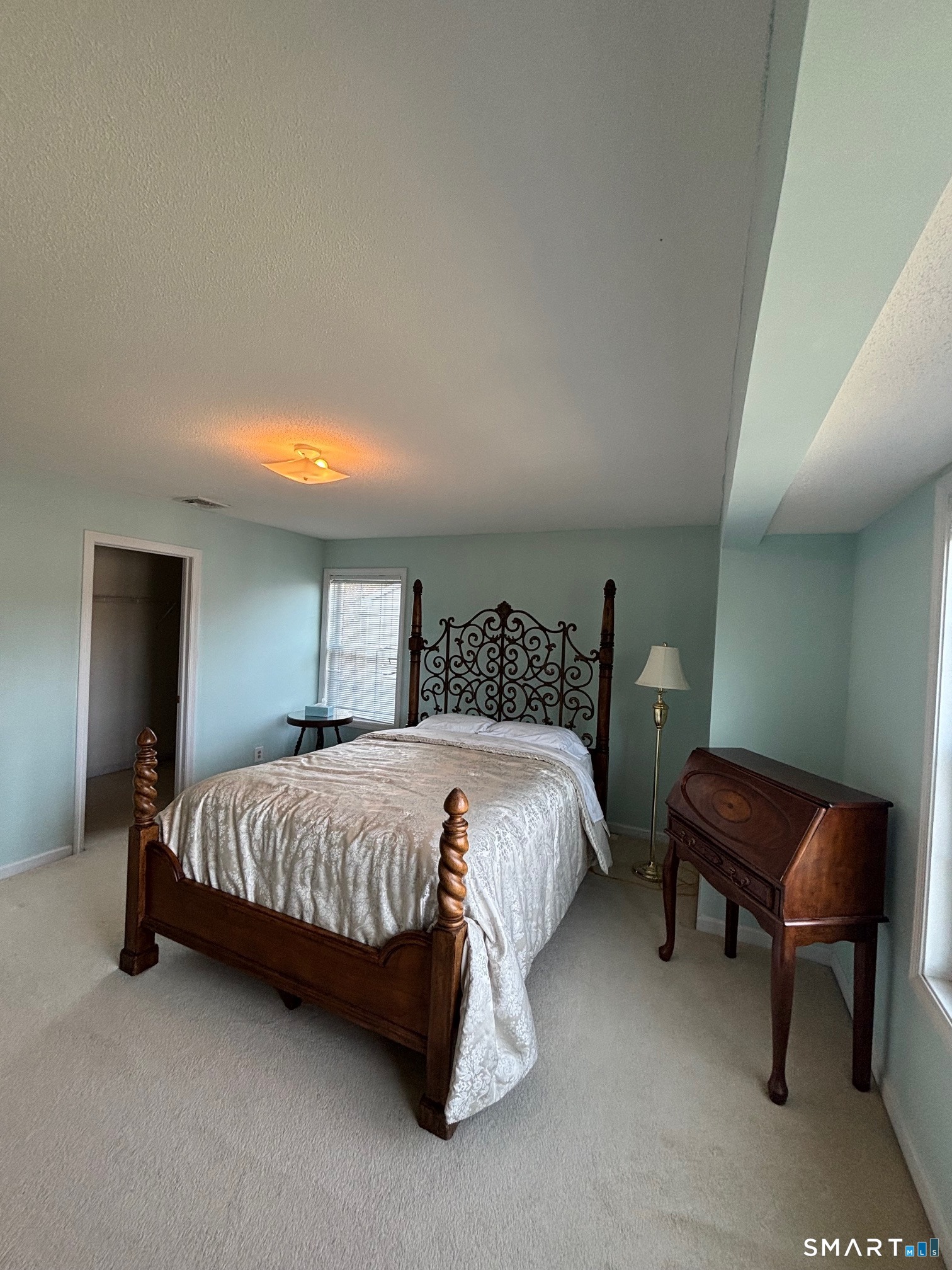 83 Danny's Way, Unit 83 Wallingford, CT 06492 - Photo 27 of 38 a bedroom with a bed and a chair