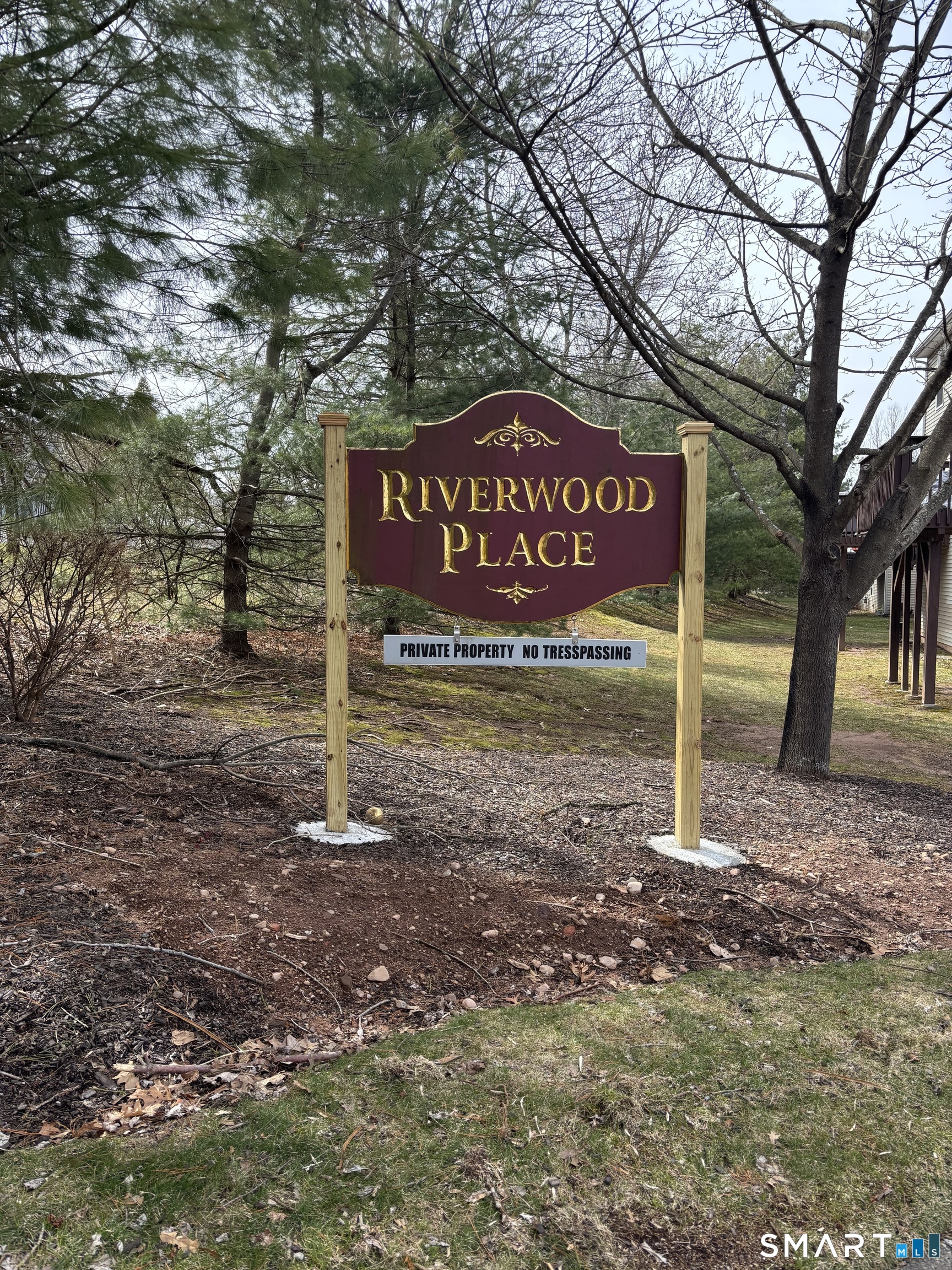 83 Danny's Way, Unit 83 Wallingford, CT 06492 - Photo 3 of 38 a street sign that is sitting in the middle of forest