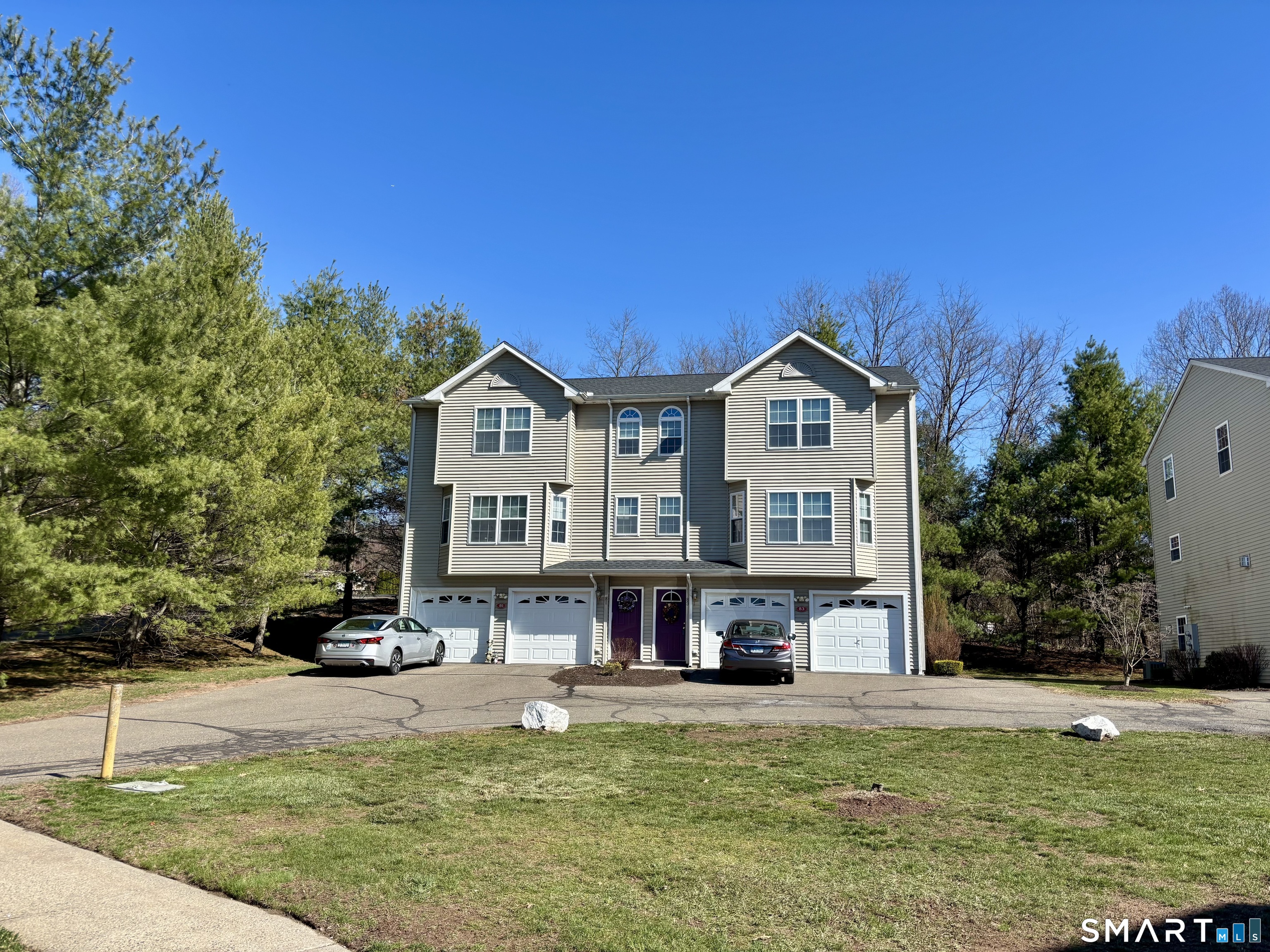 83 Danny's Way, Unit 83 Wallingford, CT 06492 - Photo 7 of 38 a view of a big house with a big yard and large trees