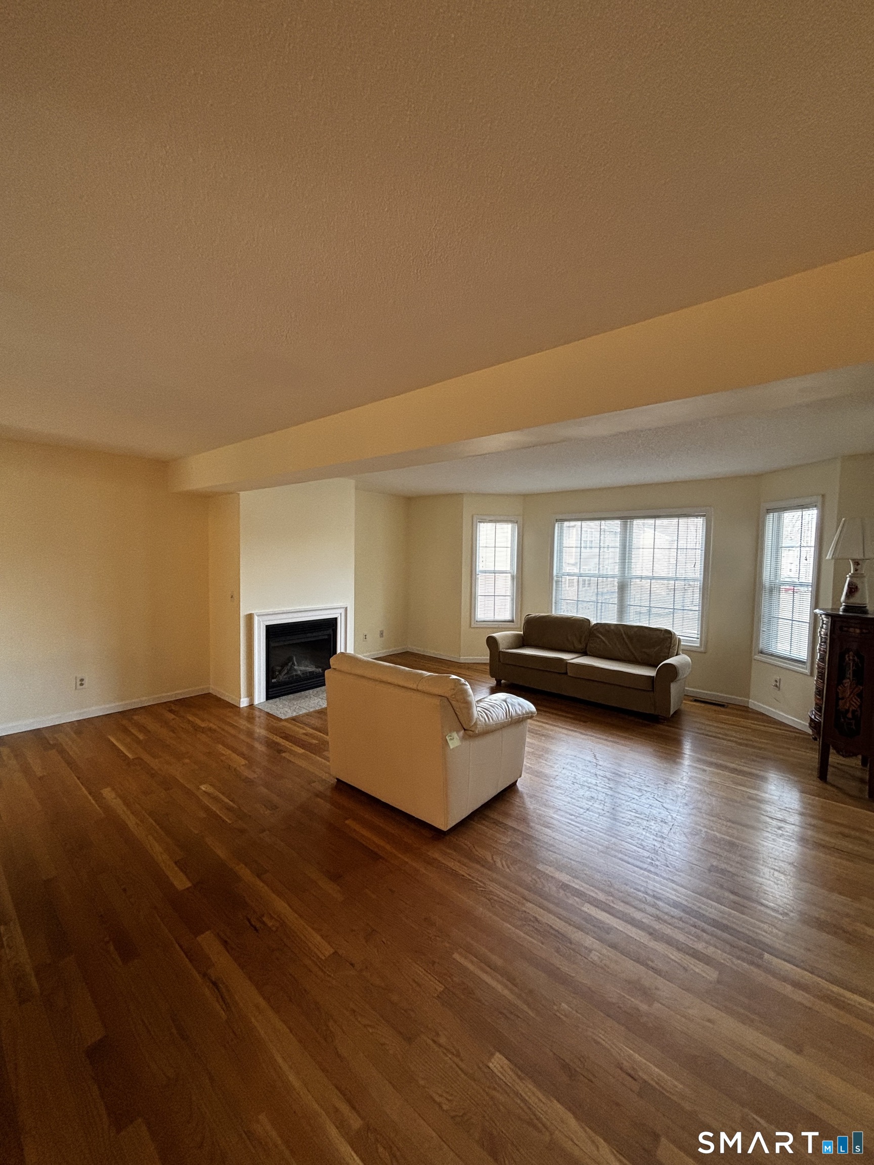 83 Danny's Way, Unit 83 Wallingford, CT 06492 - Photo 8 of 38 a living room with furniture and a fireplace