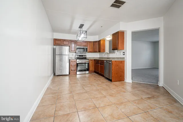 a large kitchen with cabinets and stainless steel appliances