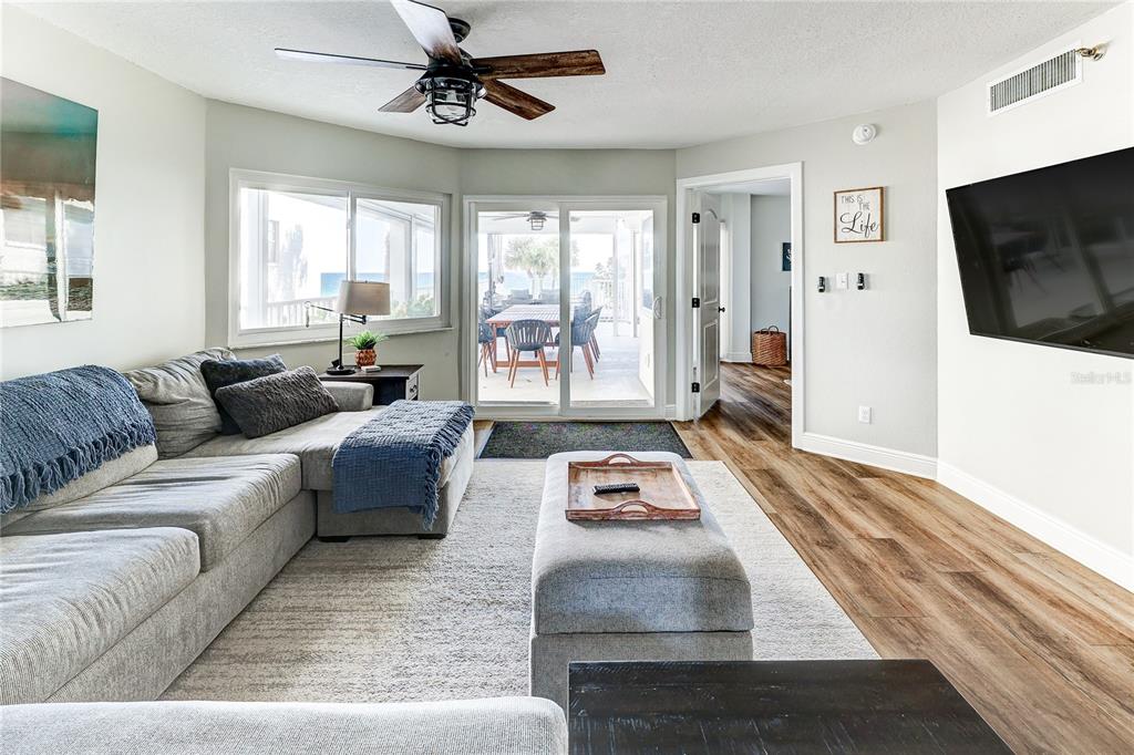 16332 Gulf Boulevard, Unit 1C Redington Beach, FL 33708 - Photo 16 of 90 a living room with furniture and a flat screen tv