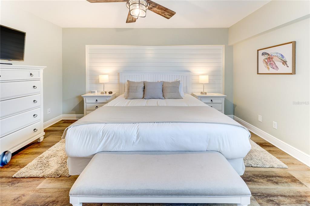 16332 Gulf Boulevard, Unit 1C Redington Beach, FL 33708 - Photo 18 of 90 a bedroom with a bed and flat screen tv