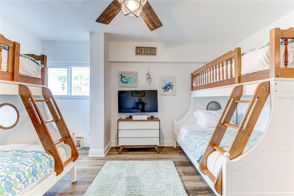 16332 Gulf Boulevard, Unit 1C Redington Beach, FL 33708 - Photo 26 of 90 a living room with furniture and a flat screen tv