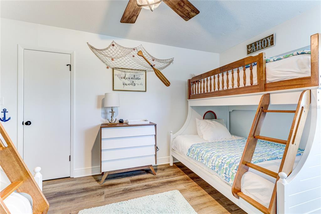 16332 Gulf Boulevard, Unit 1C Redington Beach, FL 33708 - Photo 28 of 90 a bedroom with a bed and wooden floor