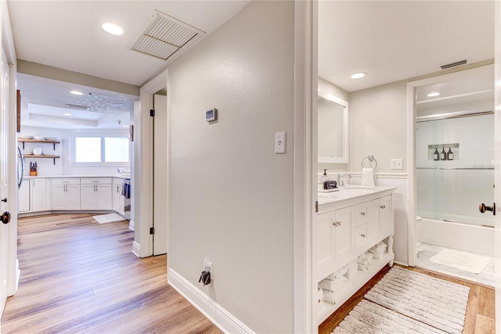 16332 Gulf Boulevard, Unit 1C Redington Beach, FL 33708 - Photo 30 of 90 a bathroom with a sink a mirror and a shower