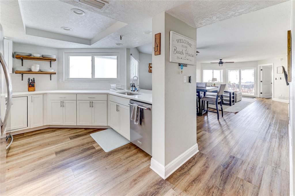 16332 Gulf Boulevard, Unit 1C Redington Beach, FL 33708 - Photo 39 of 90 a large kitchen with cabinets and wooden floor