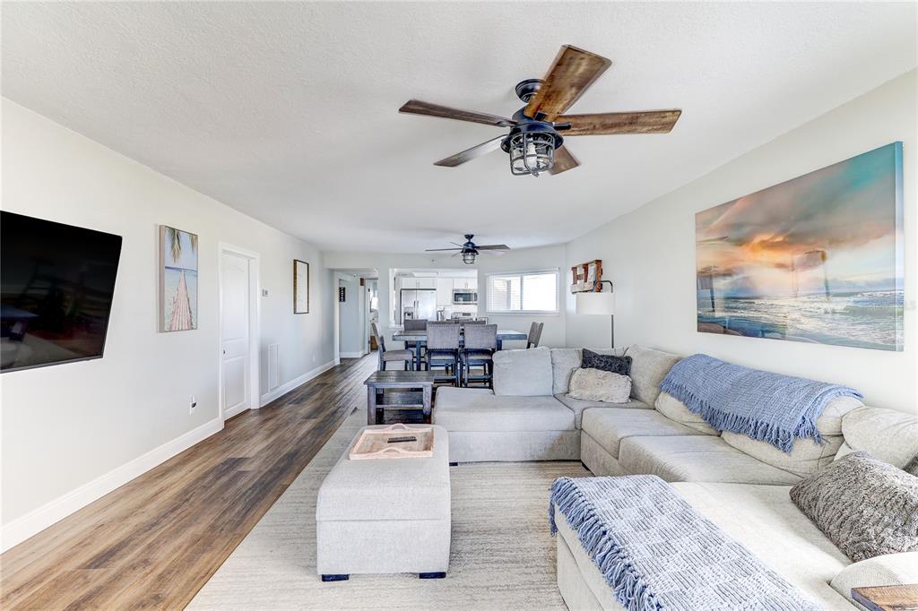 16332 Gulf Boulevard, Unit 1C Redington Beach, FL 33708 - Photo 54 of 90 a living room with furniture and a flat screen tv