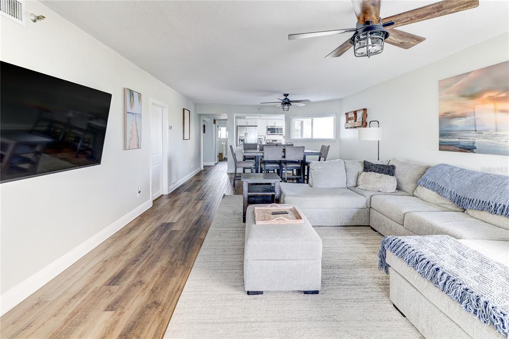 16332 Gulf Boulevard, Unit 1C Redington Beach, FL 33708 - Photo 55 of 90 a living room with furniture and a flat screen tv