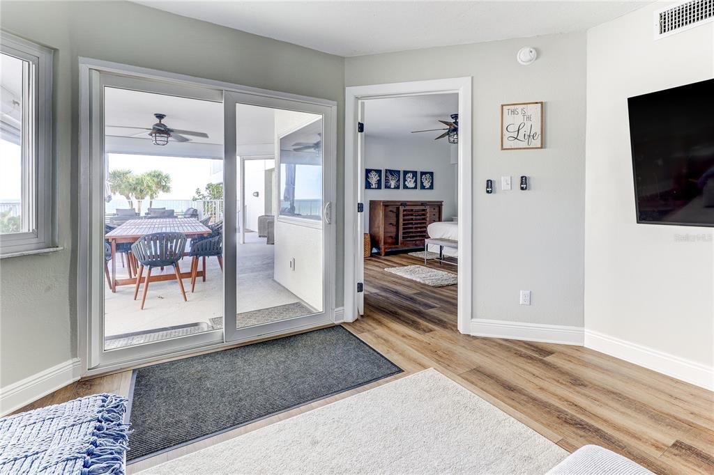 16332 Gulf Boulevard, Unit 1C Redington Beach, FL 33708 - Photo 56 of 90 a view of a hallway view with living room and wooden floor
