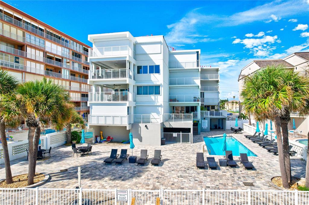 16332 Gulf Boulevard, Unit 1C Redington Beach, FL 33708 - Photo 57 of 90 a view of a building with a yard