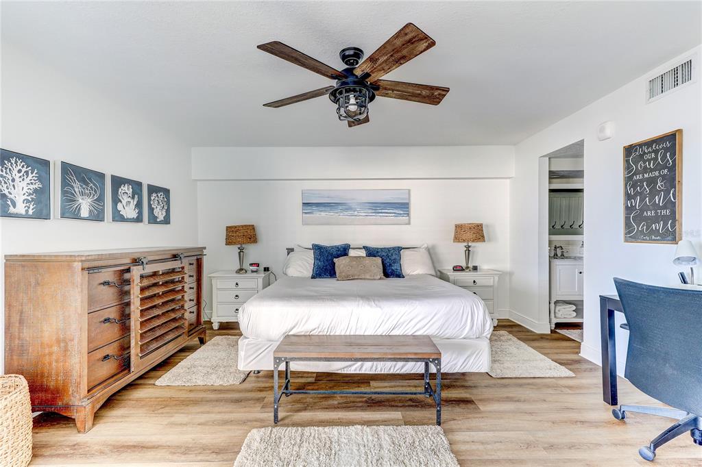 16332 Gulf Boulevard, Unit 1C Redington Beach, FL 33708 - Photo 59 of 90 a bedroom with furniture and a wooden floor