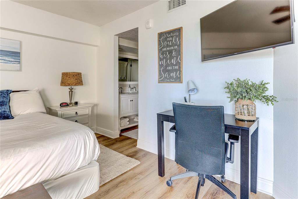 16332 Gulf Boulevard, Unit 1C Redington Beach, FL 33708 - Photo 71 of 90 a bedroom with a bed and a potted plant