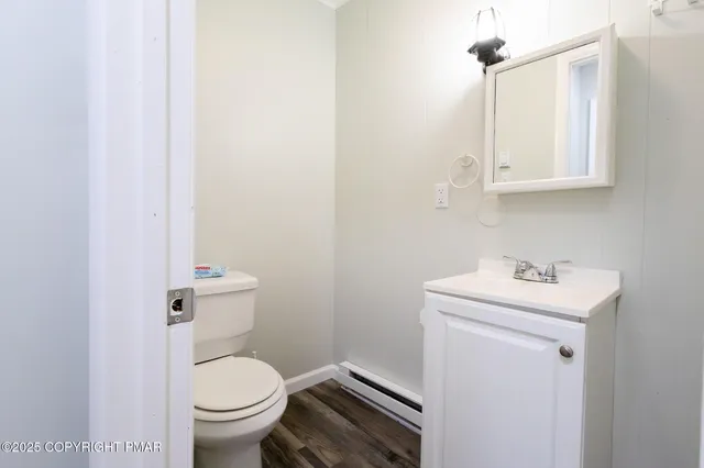 a bathroom with a sink a toilet and a mirror