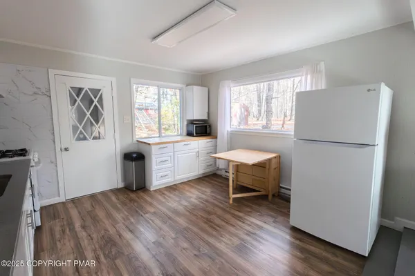 a kitchen with a refrigerator and a stove top oven