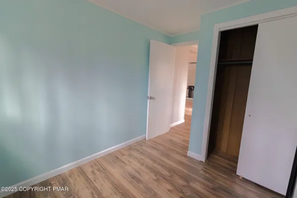 a view of hallway with wooden floor
