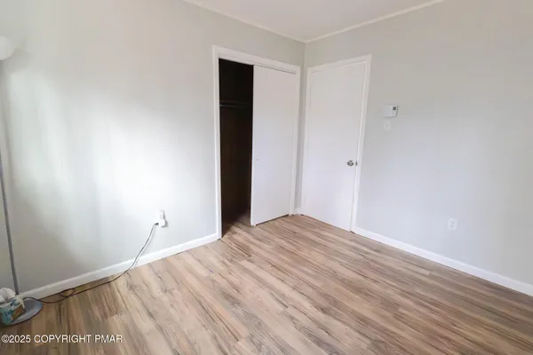 a view of room with wooden floor