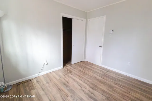 a view of room with wooden floor