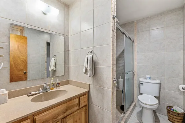 a bathroom with a sink toilet and shower