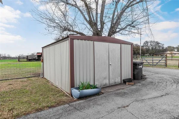 a view of a backyard with large trees
