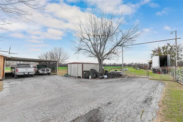 a view of a house with a cars park next to a road