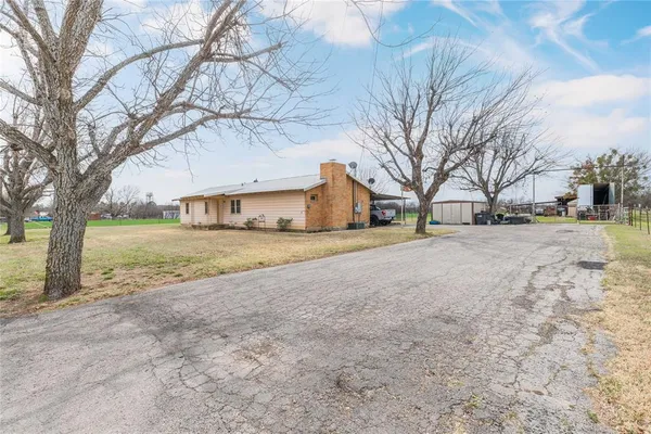 a front view of house with yard and trees