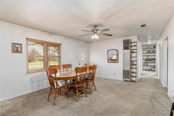 a view of a dining room with furniture and chandelier