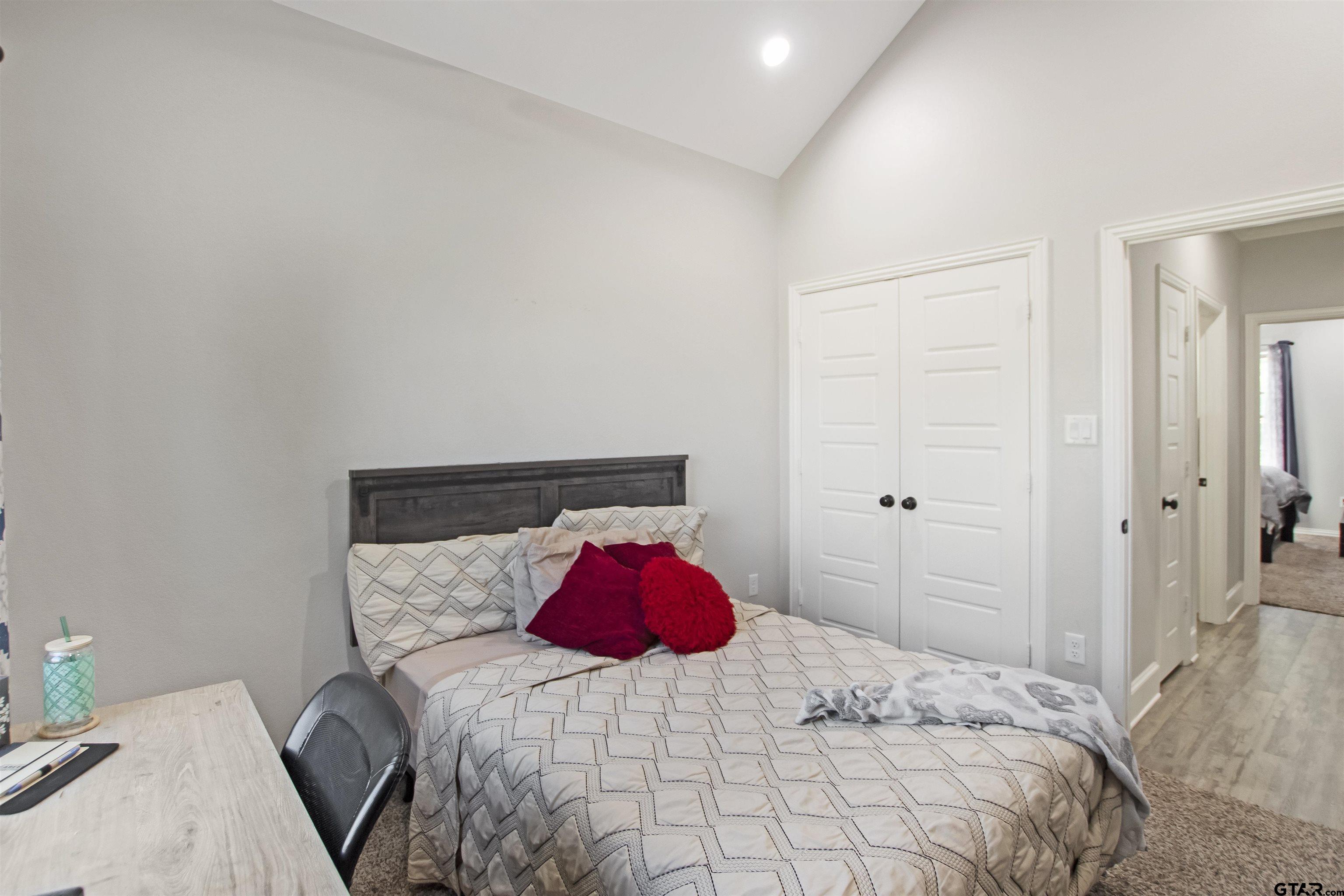 344 Duke Place Tyler, TX 75704 - Photo 17 of 36 a bedroom with a bed and a lamp