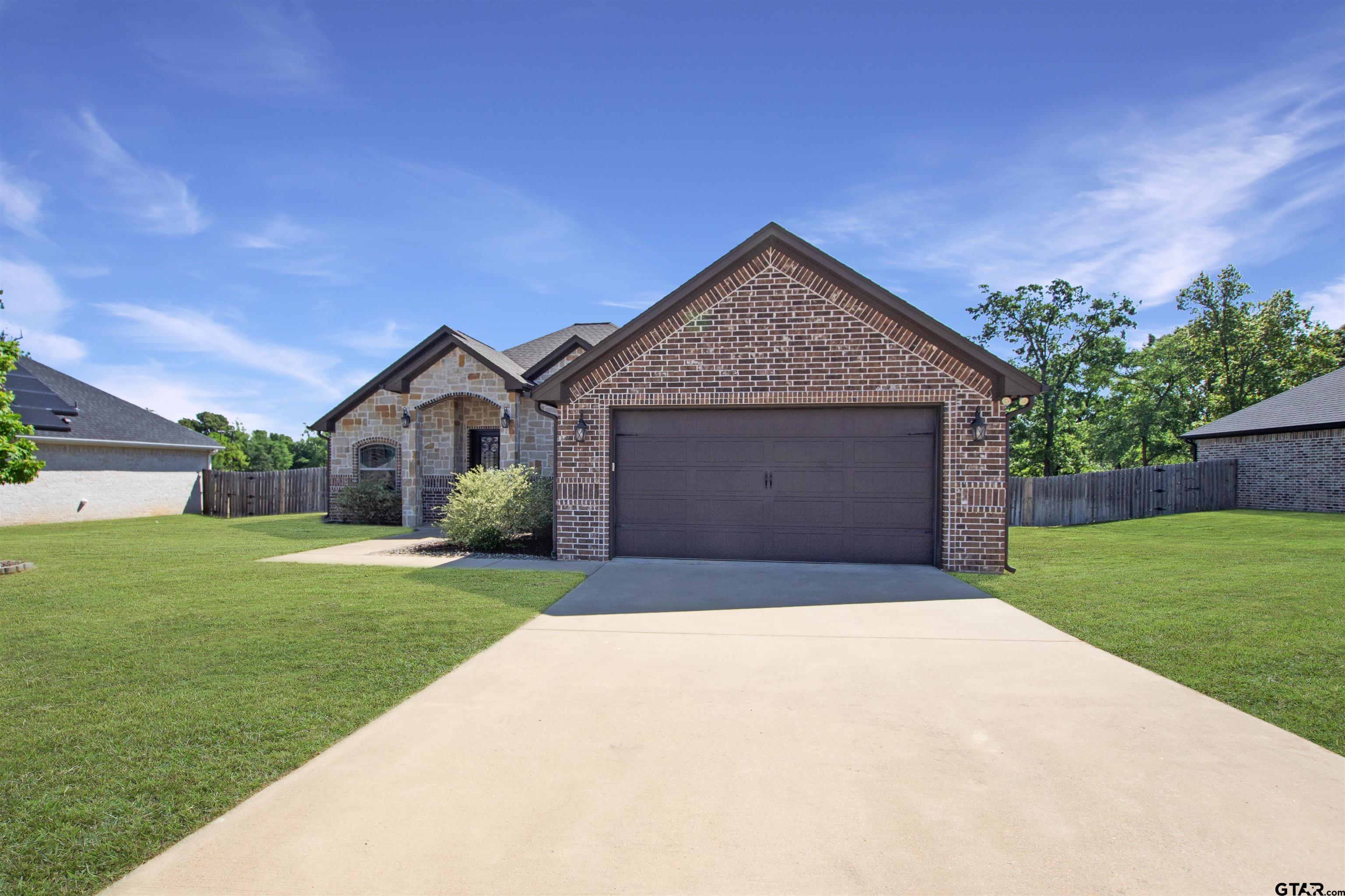 344 Duke Place Tyler, TX 75704 - Photo 2 of 36 a front view of a house with a yard and garage