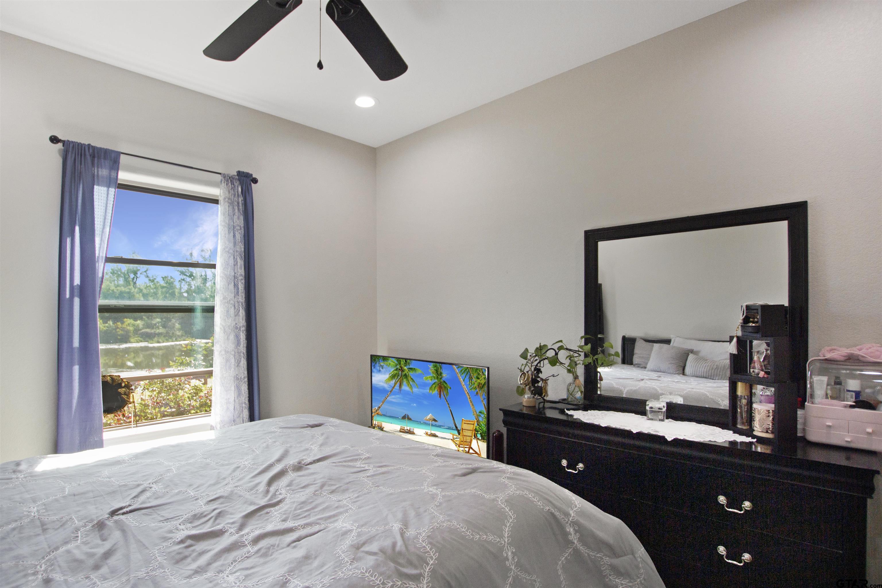 344 Duke Place Tyler, TX 75704 - Photo 21 of 36 a bedroom with a bed and a dresser