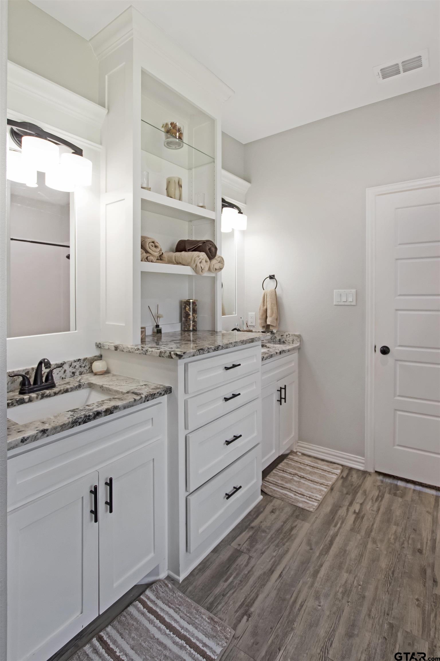 344 Duke Place Tyler, TX 75704 - Photo 26 of 36 a bathroom with a granite countertop sink and a mirror