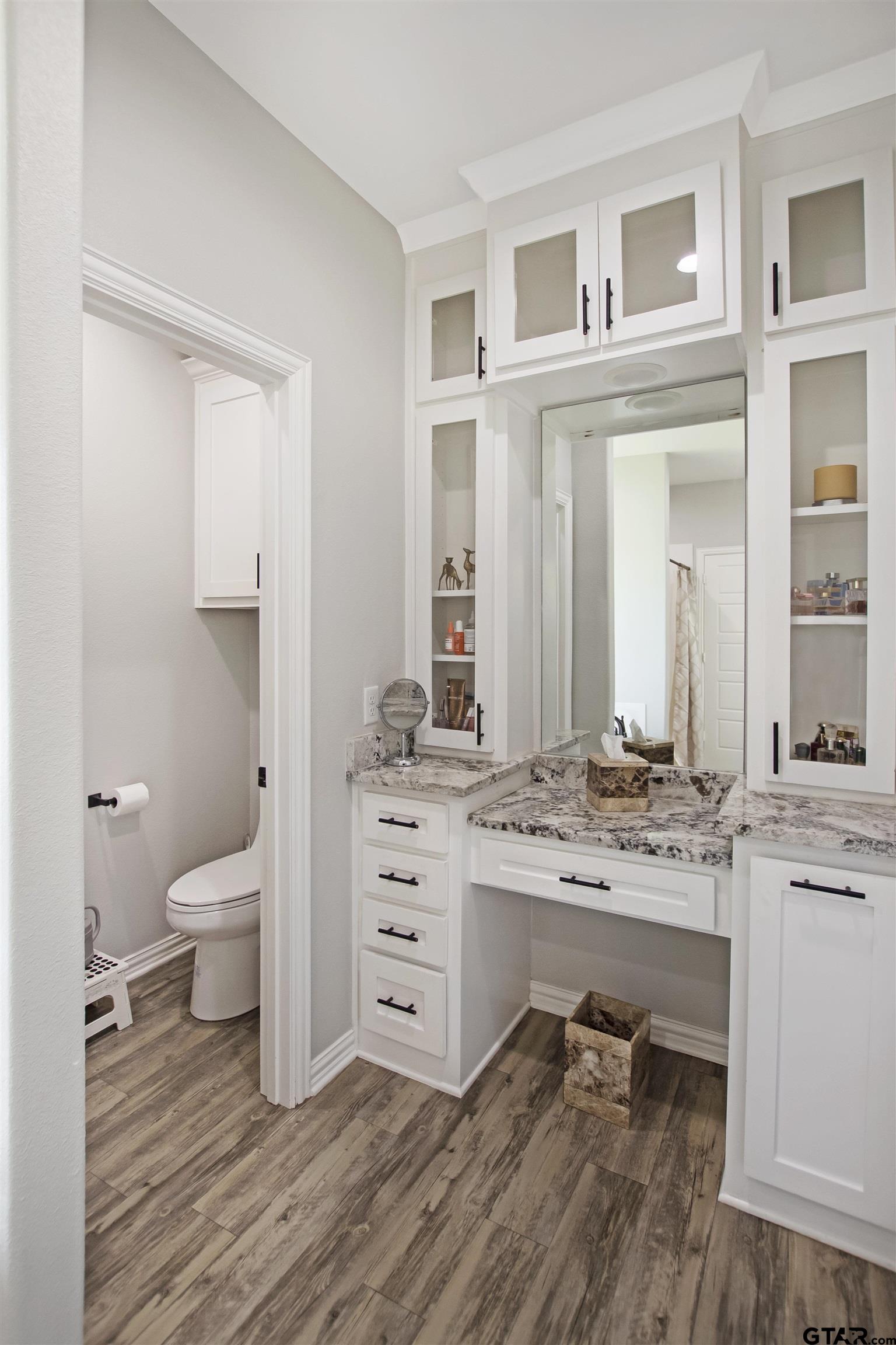 344 Duke Place Tyler, TX 75704 - Photo 28 of 36 a spacious bathroom with a double vanity sink a mirror and a toilet