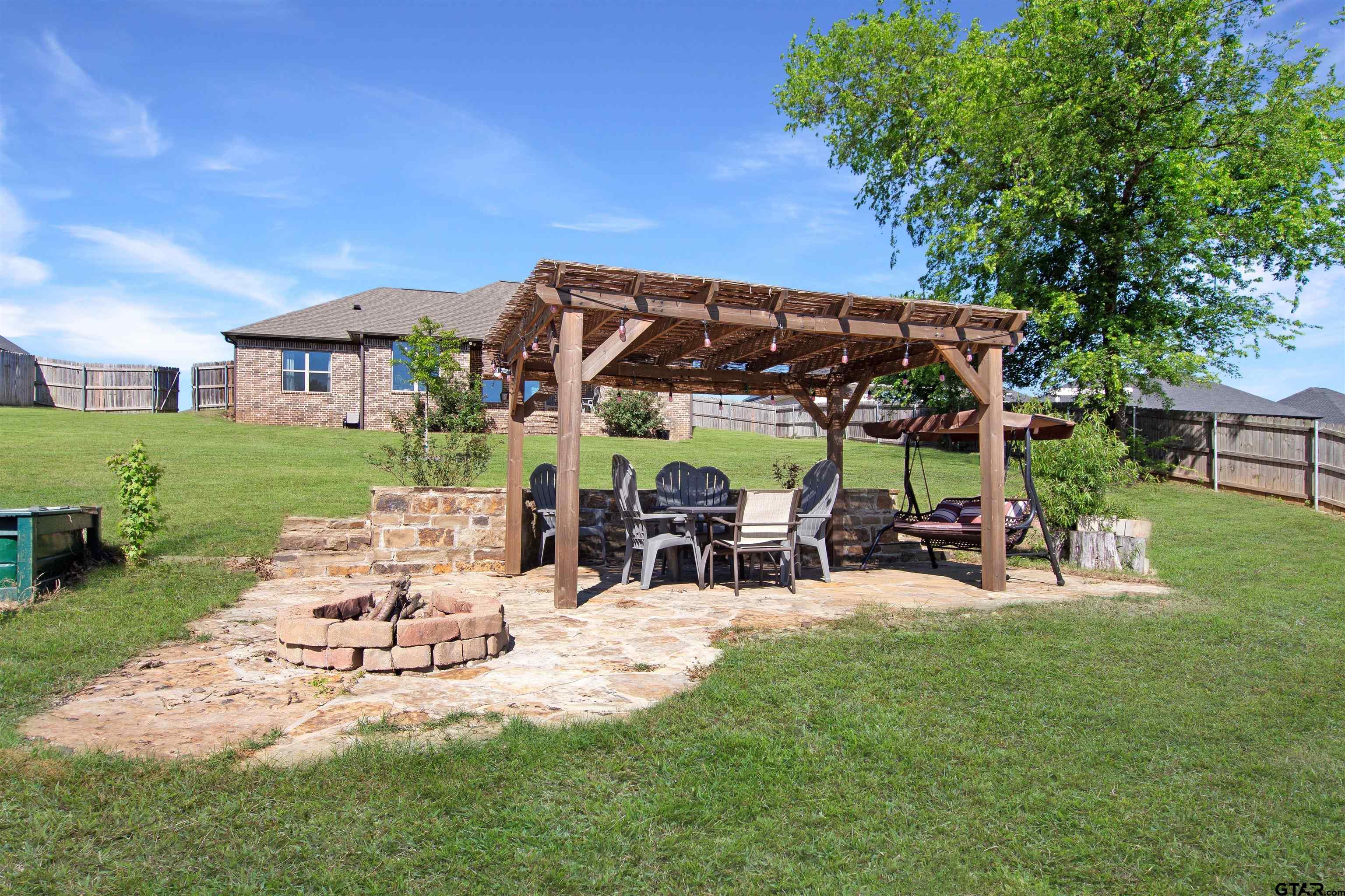 344 Duke Place Tyler, TX 75704 - Photo 32 of 36 a view of a house with backyard porch and sitting area