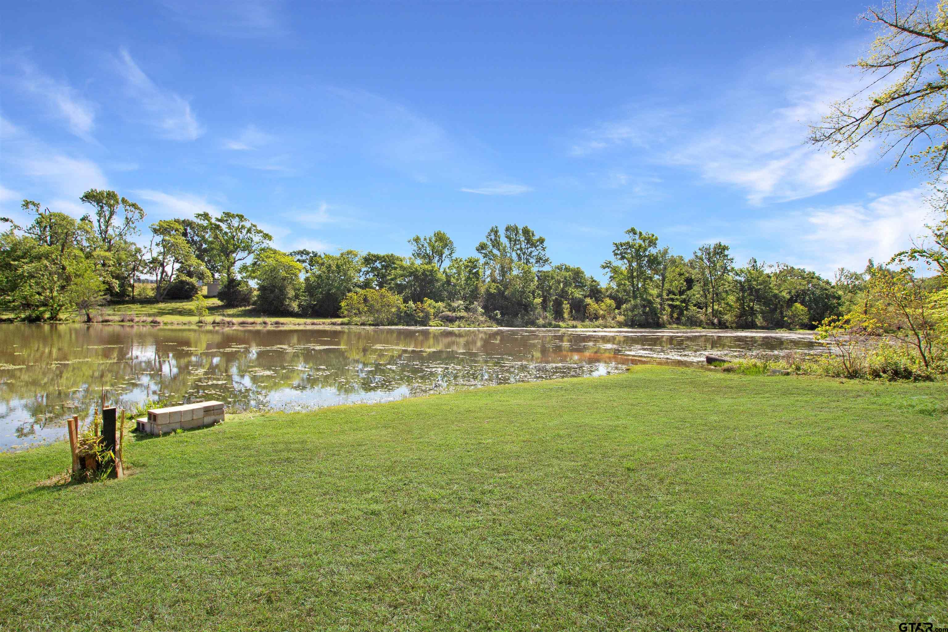344 Duke Place Tyler, TX 75704 - Photo 34 of 36 a view of a lake with houses in the back