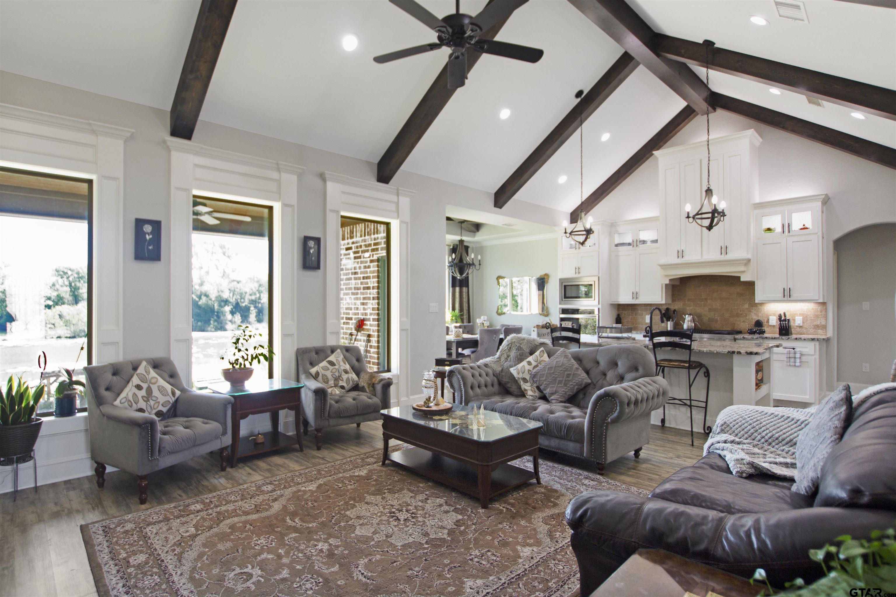 344 Duke Place Tyler, TX 75704 - Photo 6 of 36 a living room with furniture ceiling fan and a rug