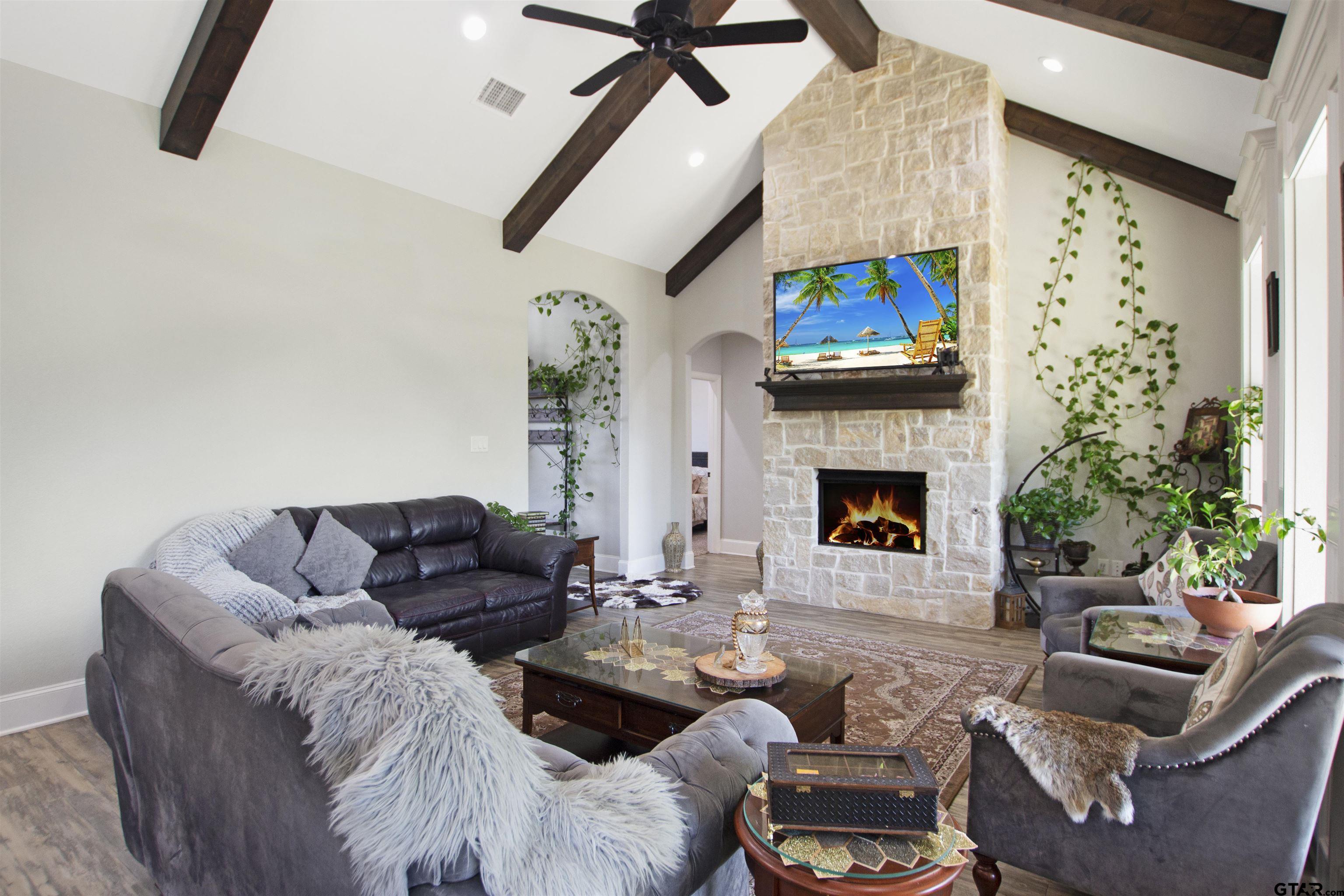 344 Duke Place Tyler, TX 75704 - Photo 8 of 36 a living room with furniture a fireplace and a flat screen tv