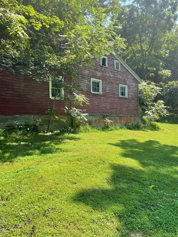 a backyard of a house with lots of green space and garden view