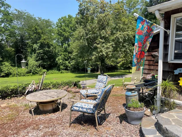 a view of a backyard with sitting area and outdoor kitchen