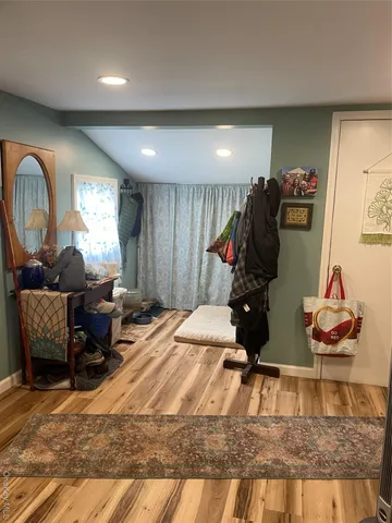 a living room with furniture and a mirror