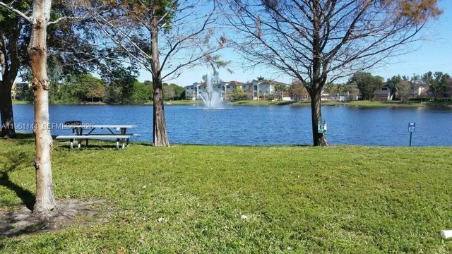 a view of a backyard with wooden fence