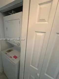 a kitchen with refrigerator and a sink