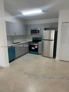 a kitchen with microwave cabinets and stove top oven