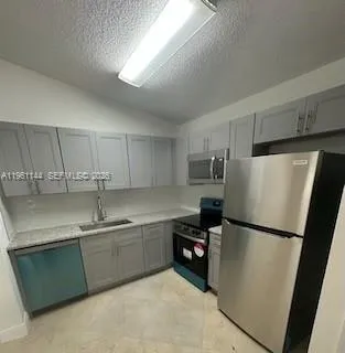 a stove top oven sitting inside of a kitchen