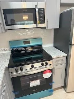 a kitchen with granite countertop a sink and a stove