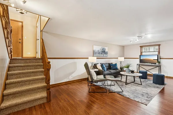 a living room with furniture and wooden floor