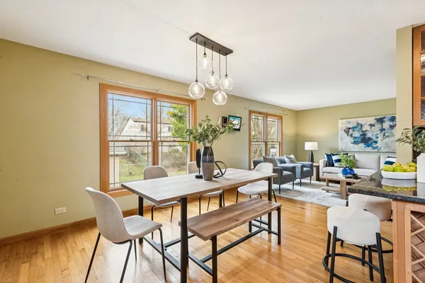 a view of a dining room with furniture a chandelier and wooden floor